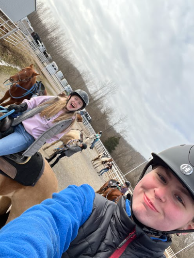 Junior Kate Wright takes a selfie with a co-worker on horseback at her job at Kraus Farms. Photo by Kate Wright.
