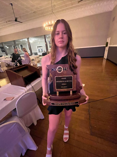 Freshman Lexi Cook holds the State Championship trophy from this year. Photo by Carly Shaffer.