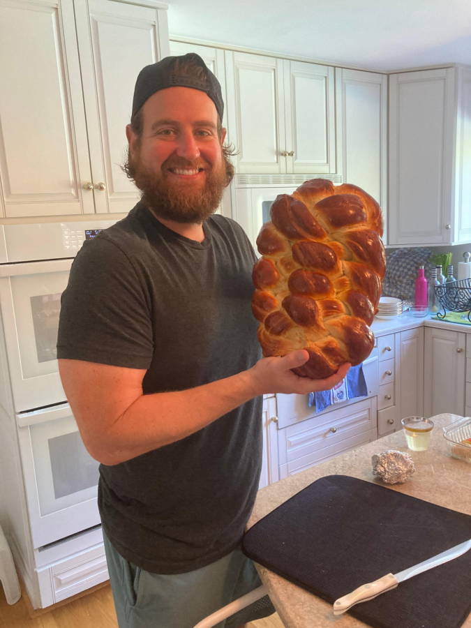 Science+teacher+Brad+Zerman+holds+up+a+loaf+of+Challah+Bread+he+baked+in+his+kitchen.