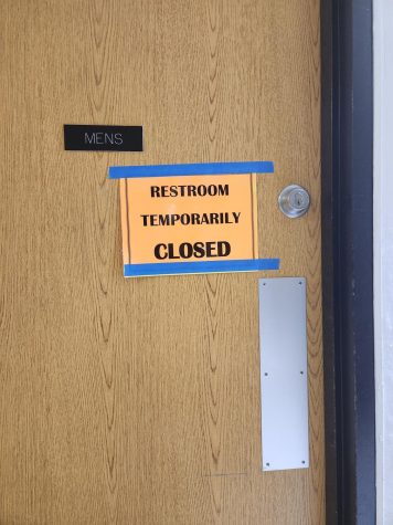 A sign on the boys restroom in the world language hallway denotes that it is closed. Photo by Marci Townsend.