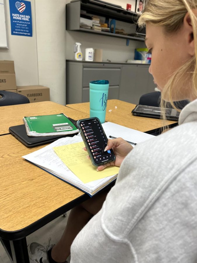 Junior Brooke Oberkramer scrolls through Snapchat during class.