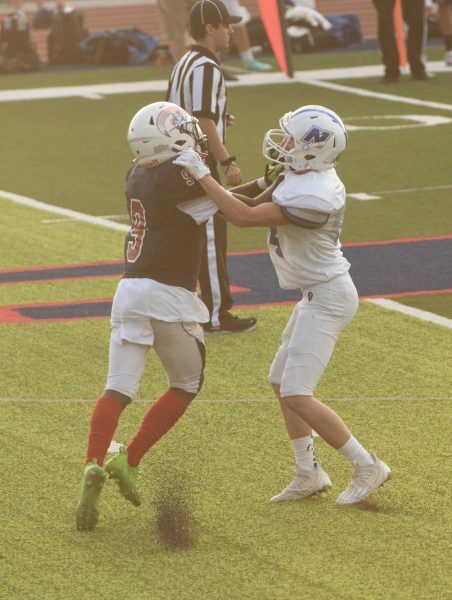 Sophomore cornerback Lamont Foster fights off a block from his Northwest opponent. The Patriots lost to the Lions in the game.