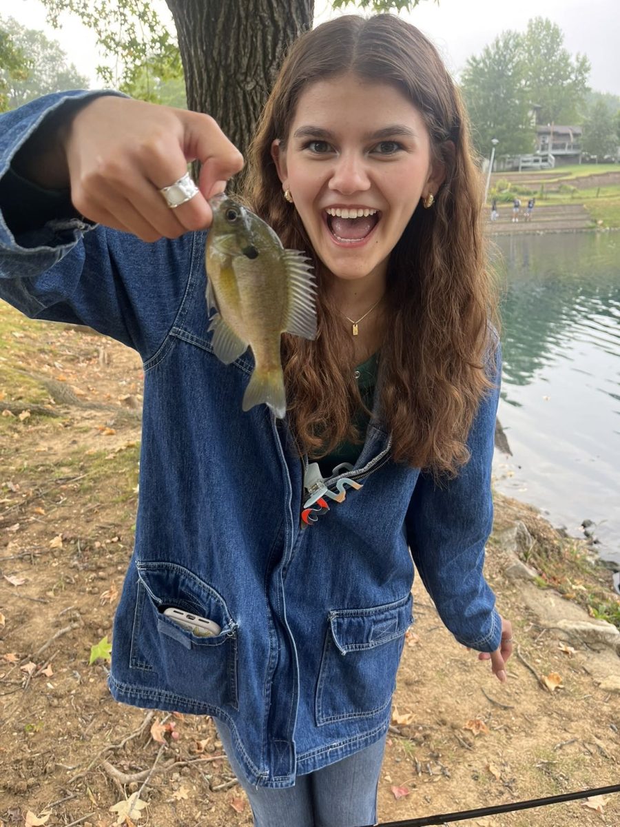 Senior+Tiana+Paul+holds+up+a+fish+she+caught+at+the+pond+in+the+Glan+Tai+neighborhood.+Paul+was+on+a+field+study+in+Mr.+Richardsons+Zoology+class.