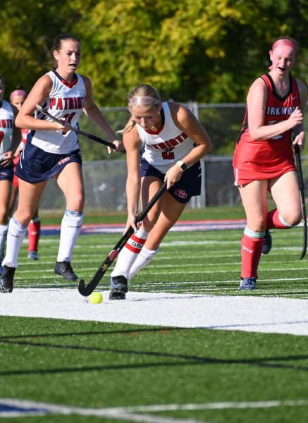 Senior Adison Irace sweeps the ball up the field in a field hockey game against Kirkwood.