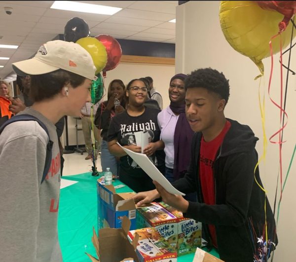 On the first day of Black History Month, sophomore Alex Swopshire gives a prize to sophomore Colin Walters after he answered a trivia question correctly. Photo courtesy of @asap_psouth