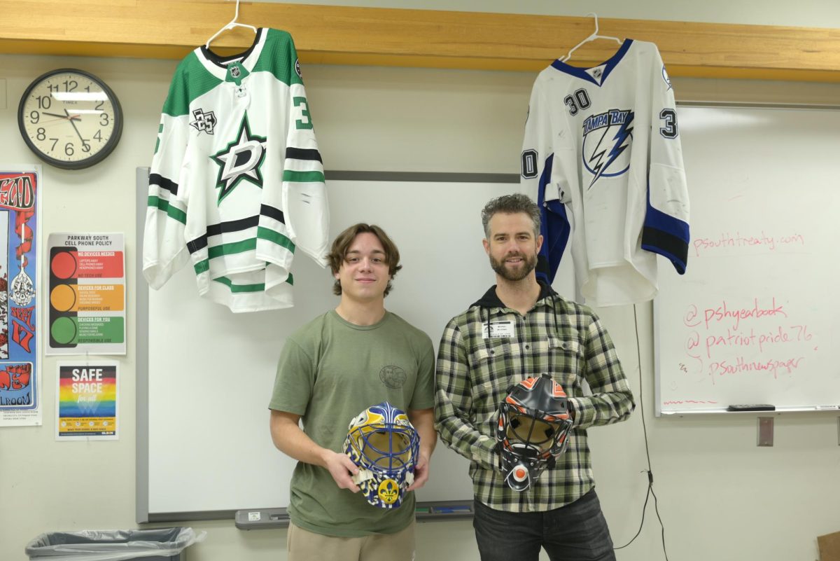 Interviewer Roman Ashman poses with McKenna and some of his game gear.
