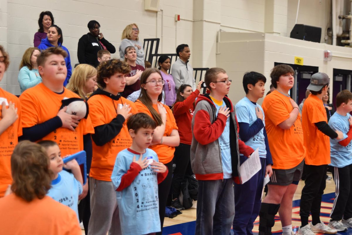 Special+Olympics+buddies+and+athletes+stand+for+the+National+Anthem%2C+before+the+event+begins.