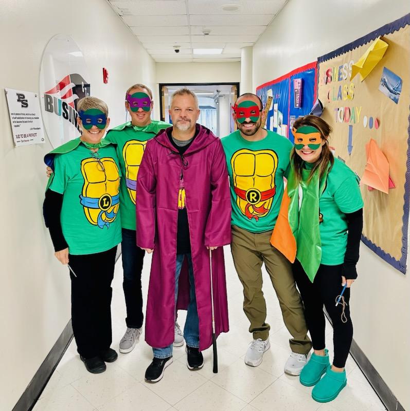 Dressed as Master Splinter, business teacher John Health poses with the other Teenage Mutant Ninja Turtles in the business department.