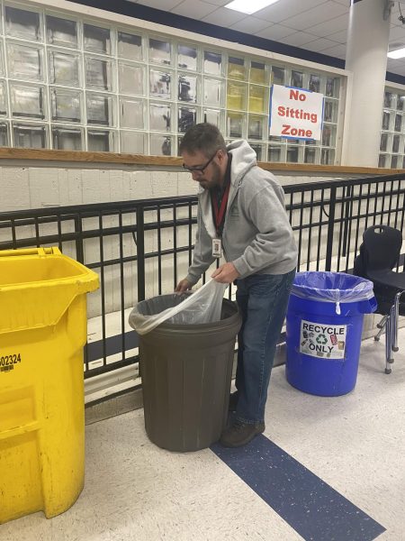 Custodian Brian Medlock empties trash cans, getting ready for the first lunch shift. Medlock is one of 8 custodians currently working at South High.