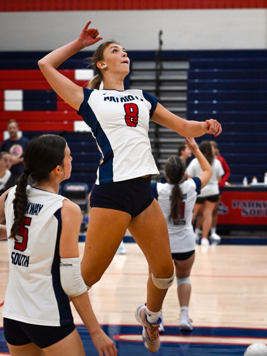 Junior middle blocker Elisabeth Uschold practices hitting during warmups before the match against Hazelwood West. 