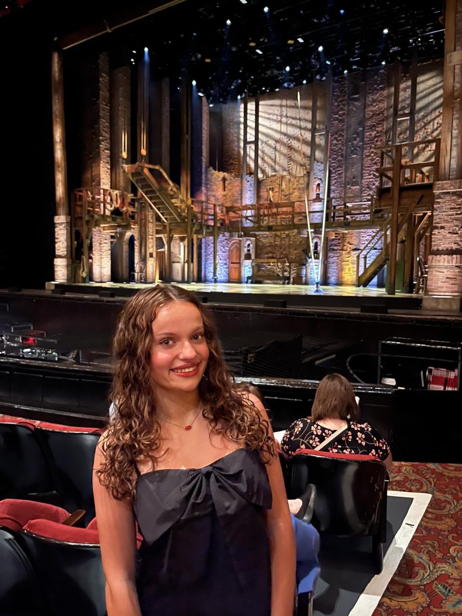 Sophomore Delaney Hinson takes a picture in front of the stage at the Fox Theater before Hamilton begins.