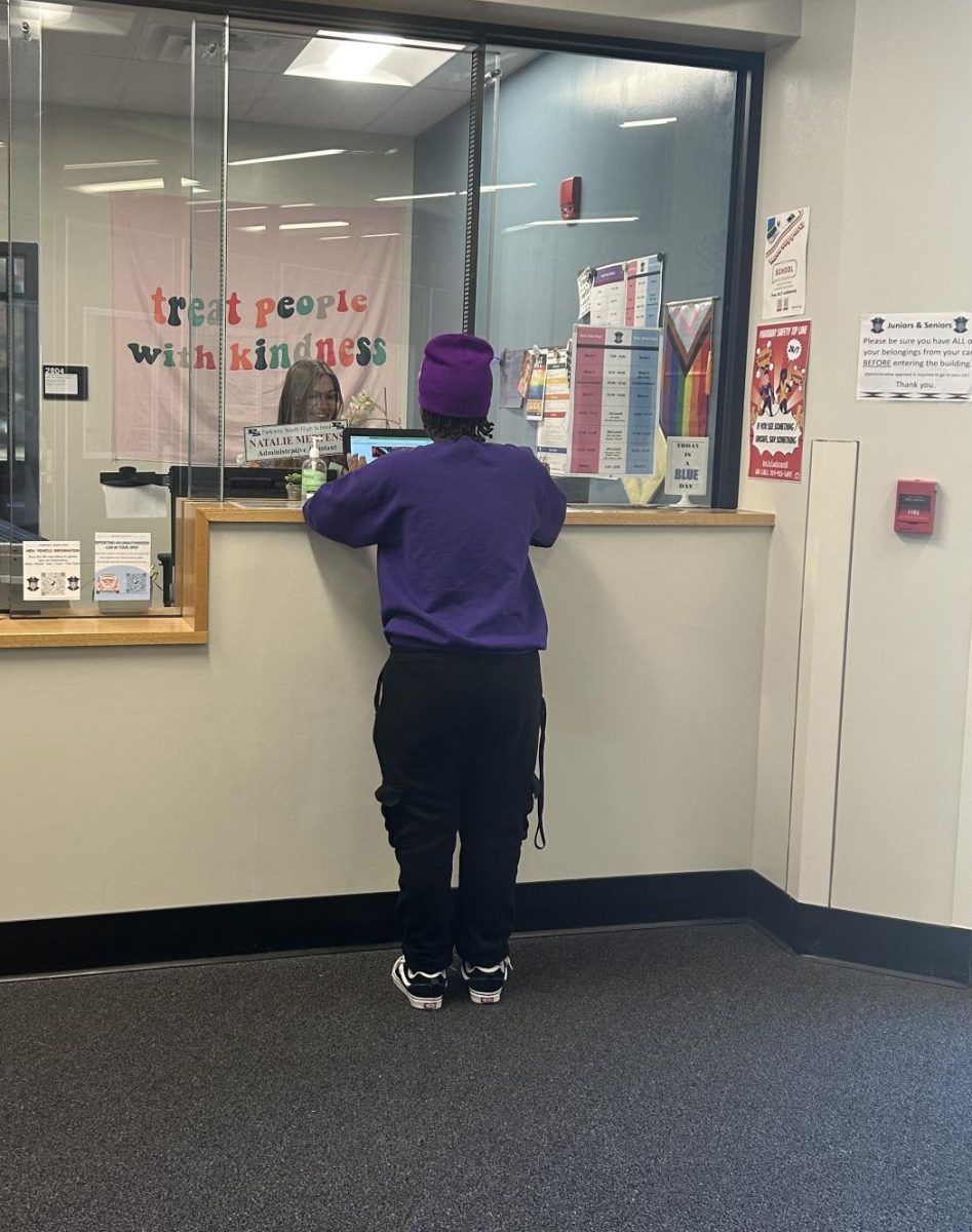 Senior Ja"Nyah Tyler signs in at the Welcome Center during 8th block. South High added a Welcome Center to help increase security in the building. 