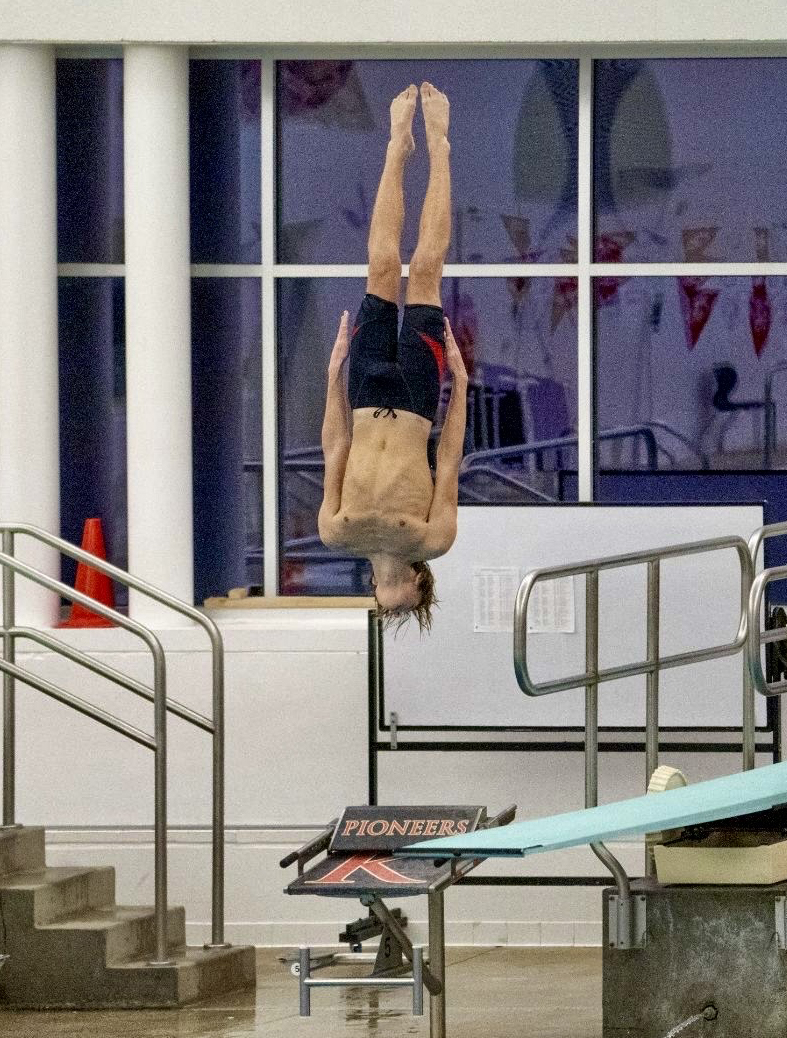 Junior Harry Pendleton straightens his body while performing a dive at meet at Kirkwood.