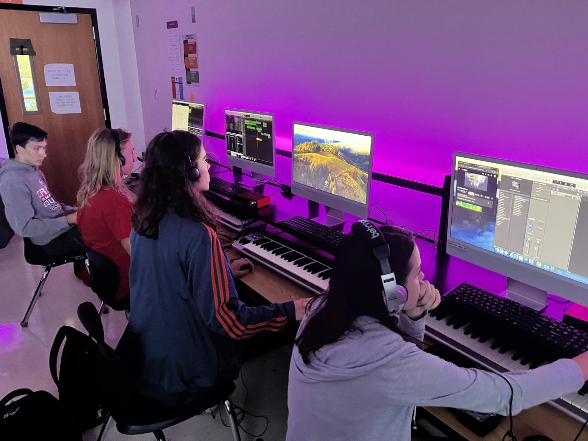 (Left to Right) Senior Nathan Schrappen, junior Aiden Johnson, junior LIam Linton and senior Sophia Kraujalis work in Mr. Menderski's Music Production class.. 