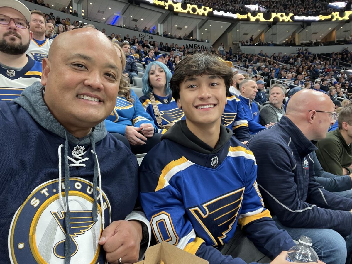 Senior Blues fan Nathaniel Kim takes a picture with his dad during the game against the Tampa Bay Lightning on Nov. 5.