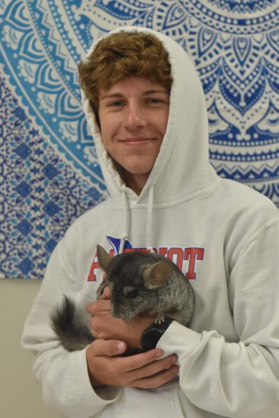 Sophomore Joey Dix holds Jennifer Berger's pet chinchilla, Smokey, during class on Wednesday.