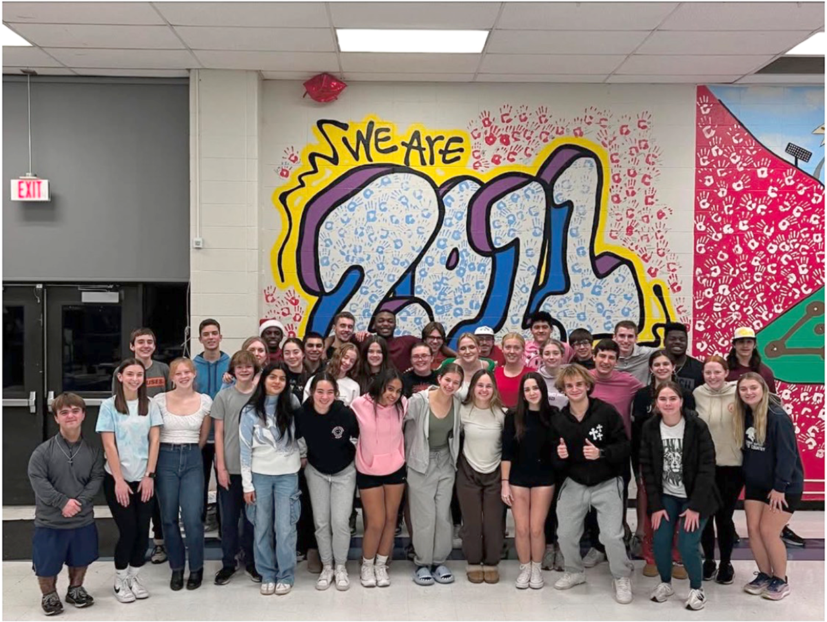 Members of the South High Fellowship of Christian Athletes chapter team up with the FCA members from West High for a group picture during their Christmas party.