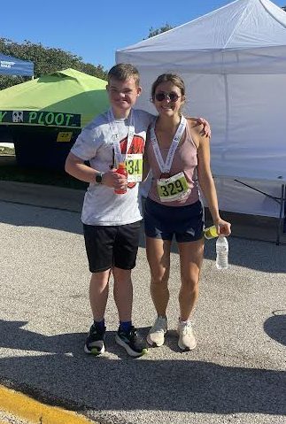 Sophomore Sam Weber takes a picture with his teacher, Elise Palmquist after they finished the Ballwin Days 5K in August.