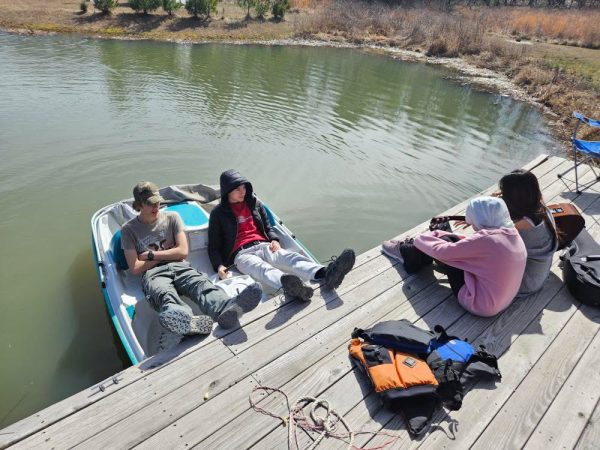 The four junior exchange students, Oliver, Cayan, Sara and Miaa relax in the sun on a lake in Bismarck, Mo.