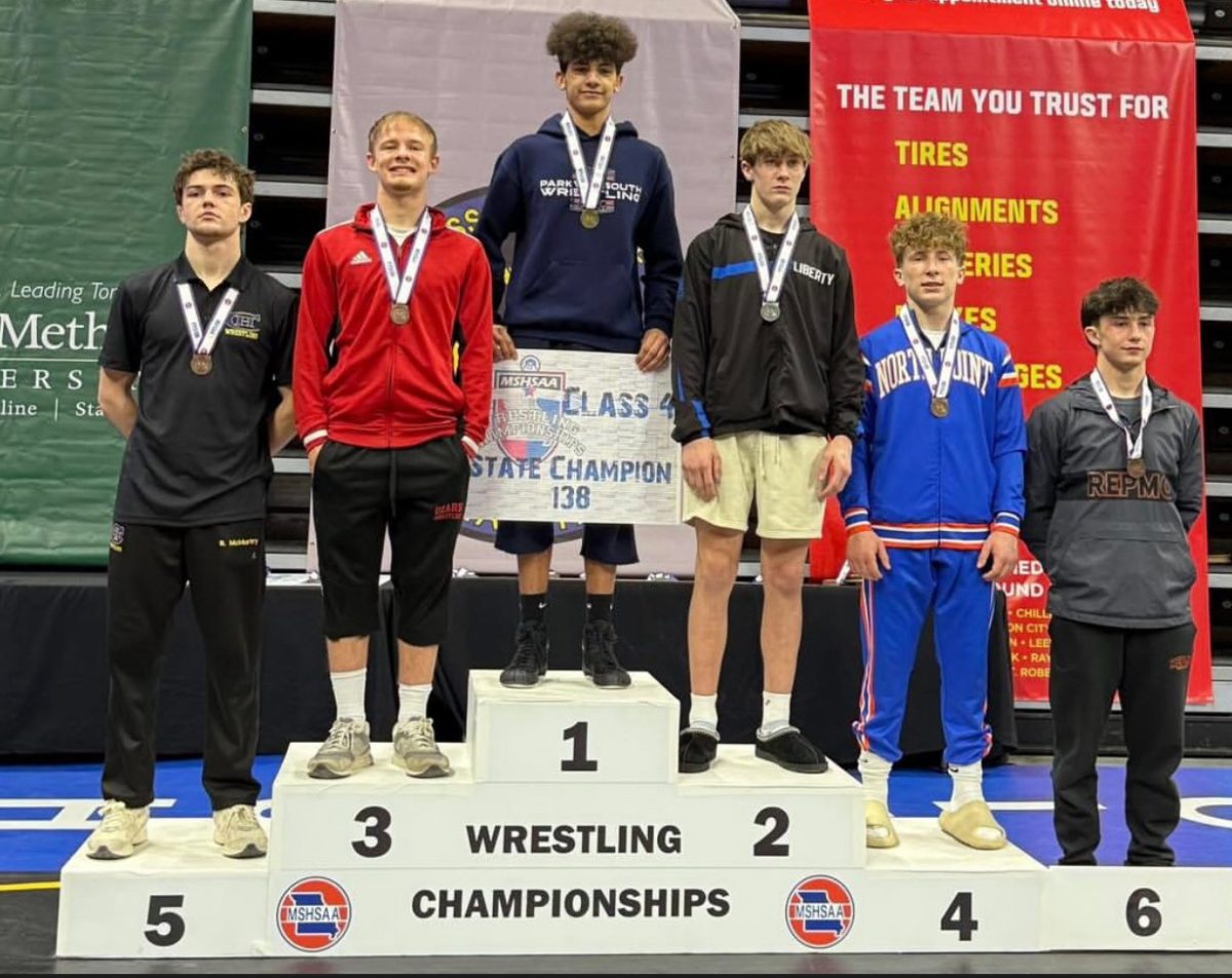 Sophomore Camron Duffield stands on the podium with the rest of the 138-pound weight class. 