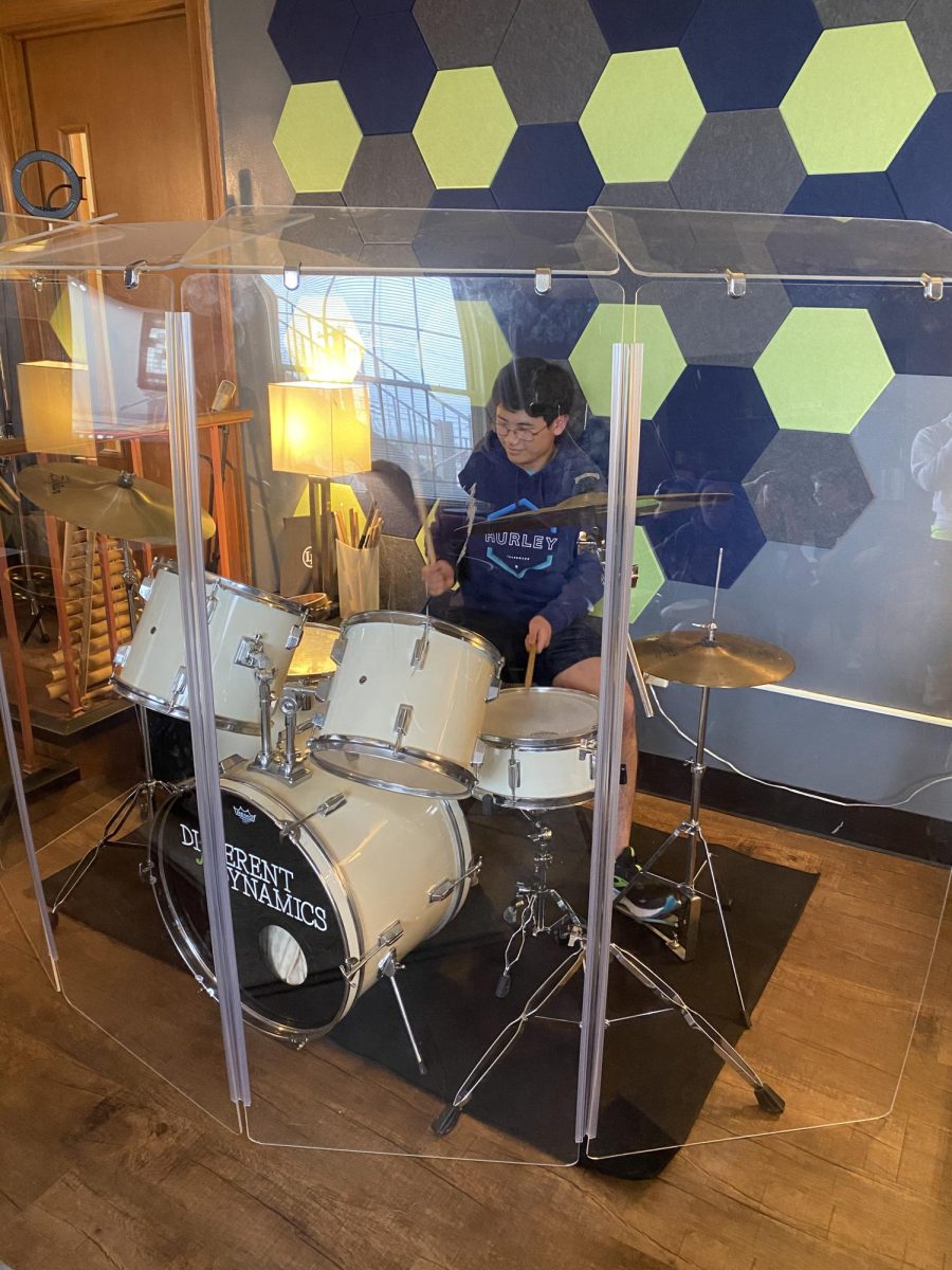 Junior Andrew Tsai, a student in Ms. Arbini's Let's Make Music Together class, plays the drums on the class field trip to Music Development Studios.