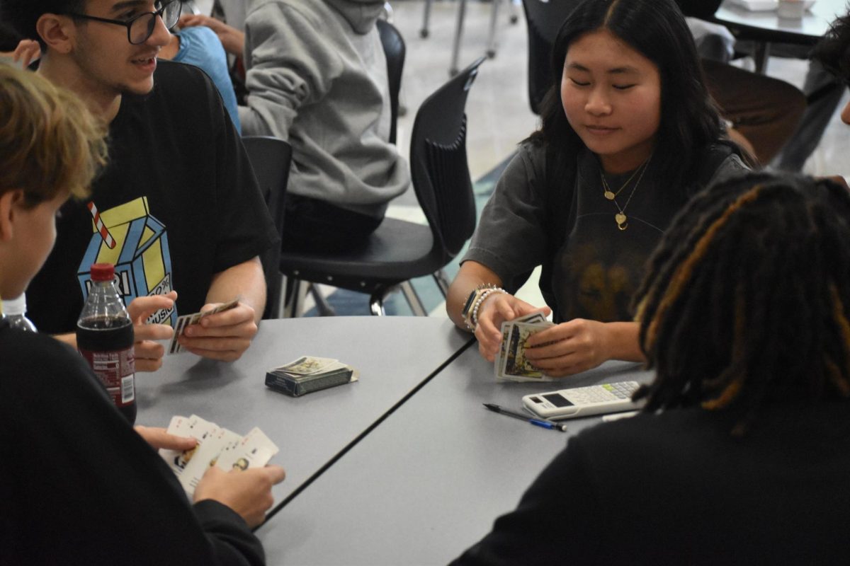 Sophomores Jack Flynn, Tayem Saleh, Chloe Rodriguez and Savannah Swinton play a game of cards during lunch on Sept. 5. 