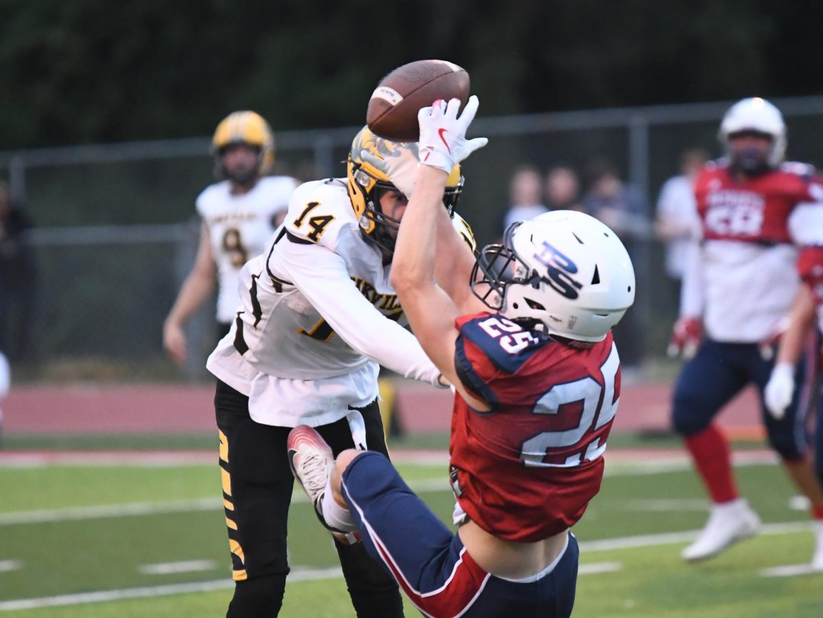 Senior cornerback Joey Morrow falls to the ground with the interception in his hands.