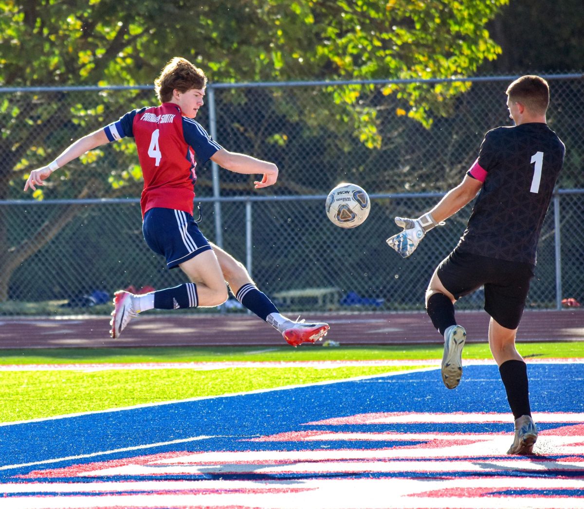 With focus and determination, senior striker Ethan Carroll (#4) takes flight for a powerful shot on goal during South's matchup against Parkway North on Sept. 25. Carroll showcased his leadership and skill as he led the Patriots in the win over the Vikings. "I enjoy being the guy people come to if they need help with soccer. Being the striker I contribute to the team by scoring goals."