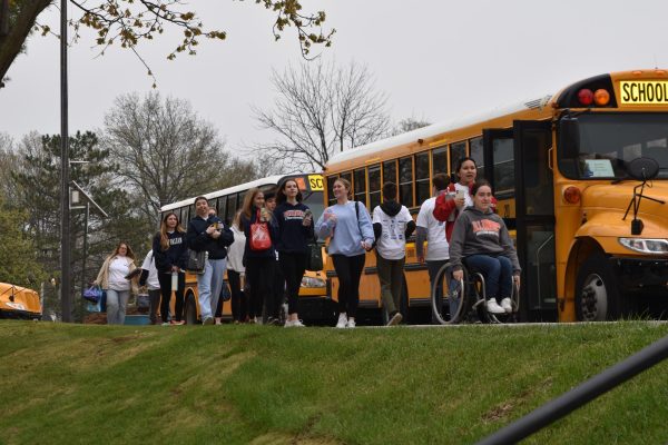 Students board buses headed out to serve their wider community.