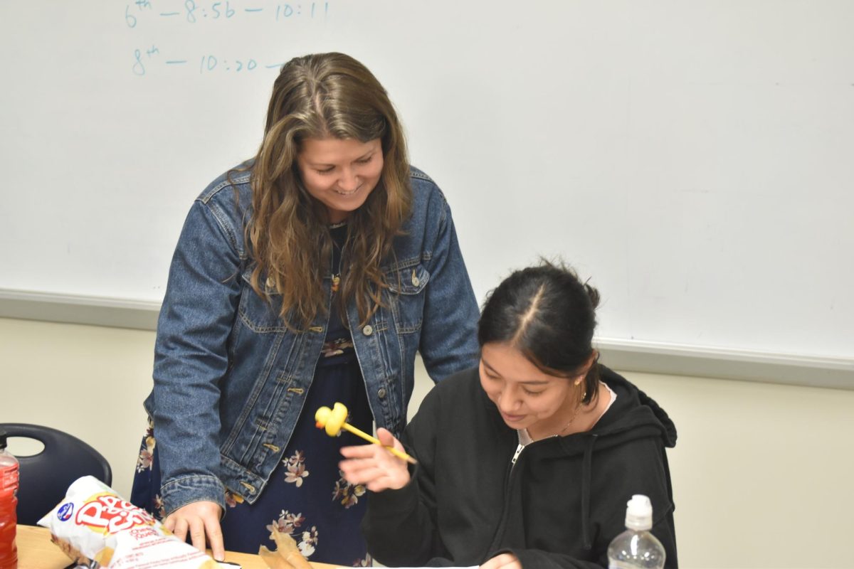 ELL teacher Whitney Wilhelm helps sophomore Eileen Tapia-Bello with her work. 