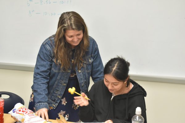 ELL teacher Whitney Wilhelm helps sophomore Eileen Tapia-Bello with her work. 