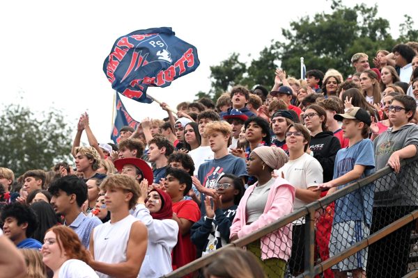Members of the Posse cheer on the Patriots in the first home football game of the season. Now much of the Posse leaves after the first half.