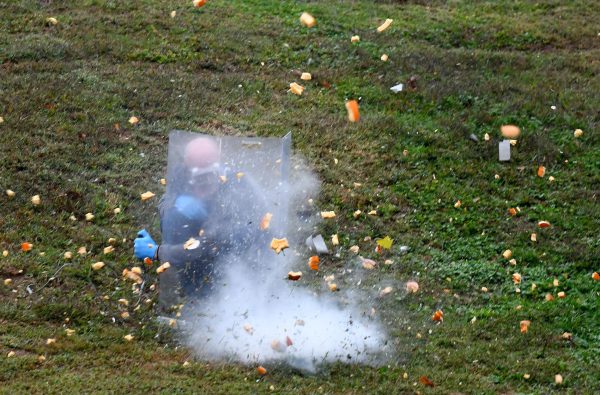 Bits of pumpkin explode all around science teacher Sergey Zinovchik as he is protected by a blast shield during his 3rd block Physical Science class, Oct. 27. Zinovchik has exploded watermelons and pumpkins every year since he began teaching at South. "[The experiments] get students excited about science, specifically chemistry. [I also do them] to recruit interest in upper-level chemistry (AP Chemistry) also as a treat for taking a tough class here at Parkway South."