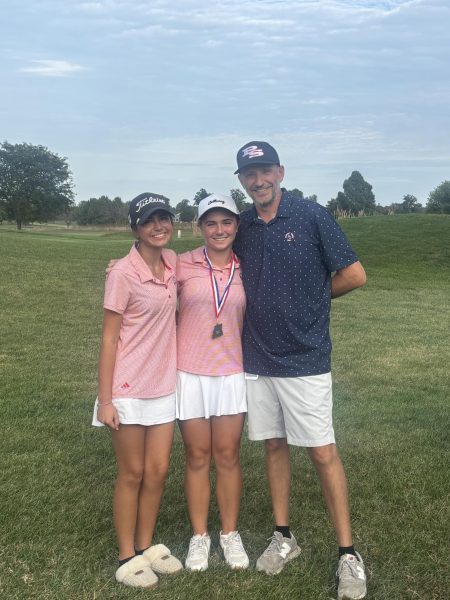 Sophomores Audrey Miller and Ashtynn Zuniga take a picture with Coach Adam Weiss after districts. The Patriots took fifth place in the event and Audrey and Ashtynn qualified for state.