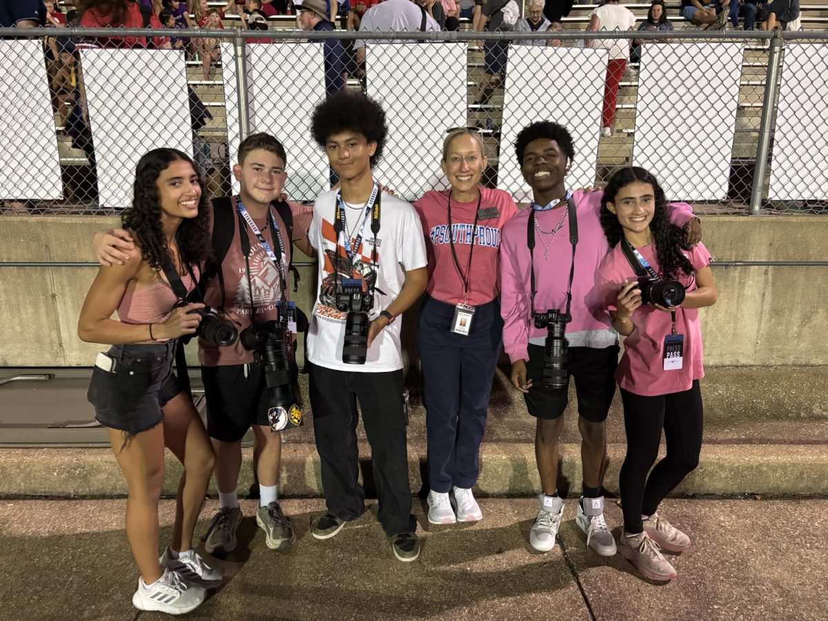 Superintendent Melissa Schneider takes a photo with South High photojournalists Emilly Lima, Ethan Thompson, Ben Besic, Tramon Jackson, and Evelly Lima at the home football game, Oct. 3.