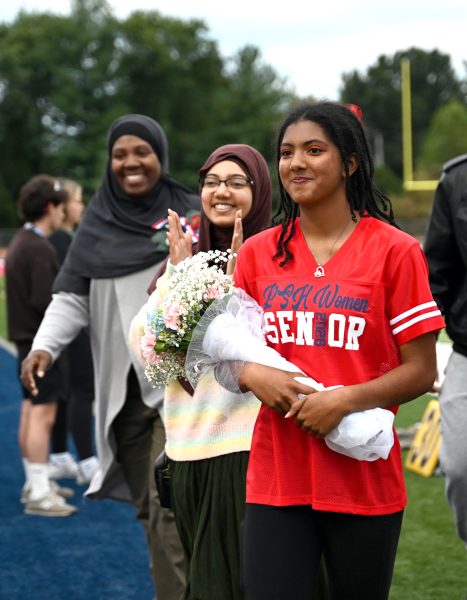 With her mom and sister cheering her, senior Maiyah Syed gets recognized on Senior Night for Color Guard, Oct. 10. "It felt pretty good [to be recognized]. I thought it was nice to have all my accomplishments laid out [by the announcer.] [I'm really going to miss] the evening practices and the bonding with the team over everything," Syed said. 