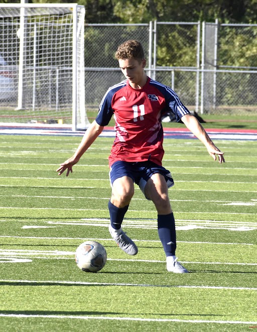 Senior Samuel Amad dribbles the ball downfield.