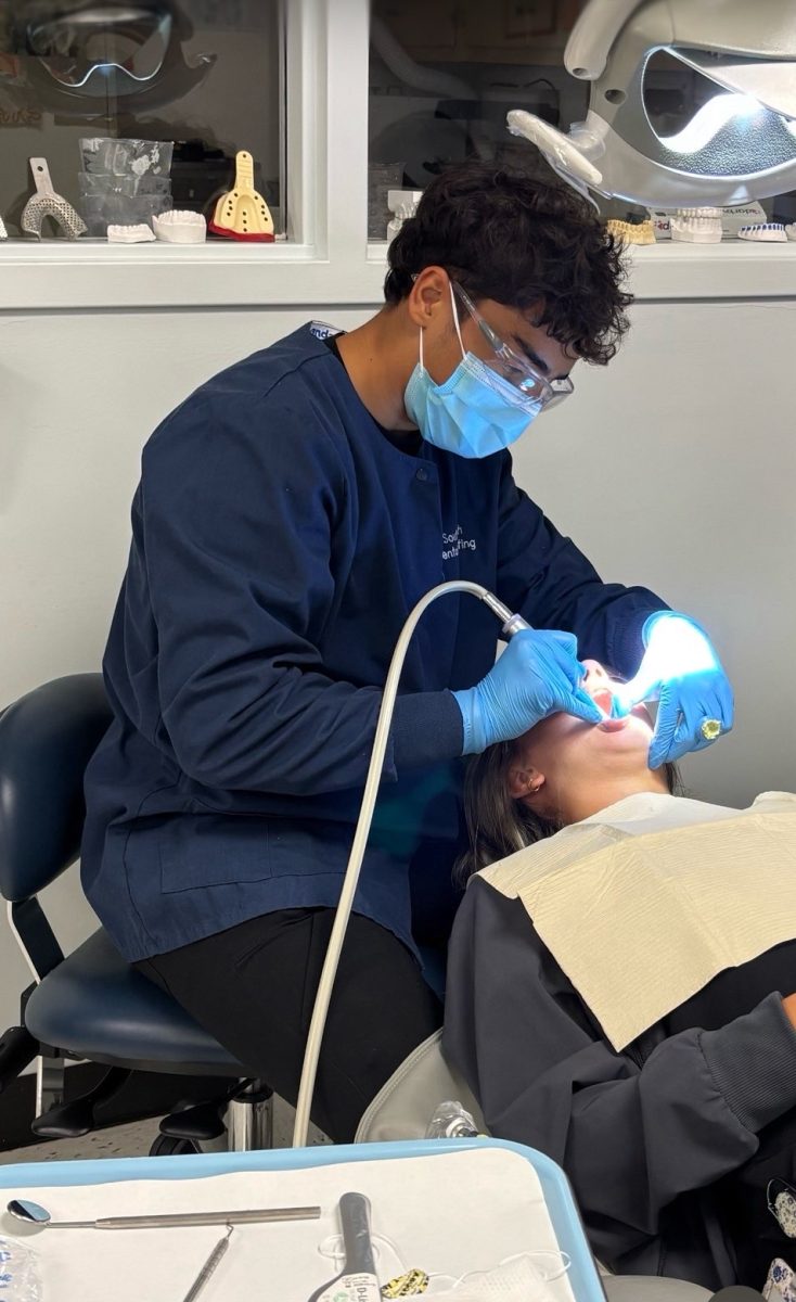 Senior Suroosh Weedy practices "coronal polishing" on a classmate during his Dental Sciences class at South Tech. 