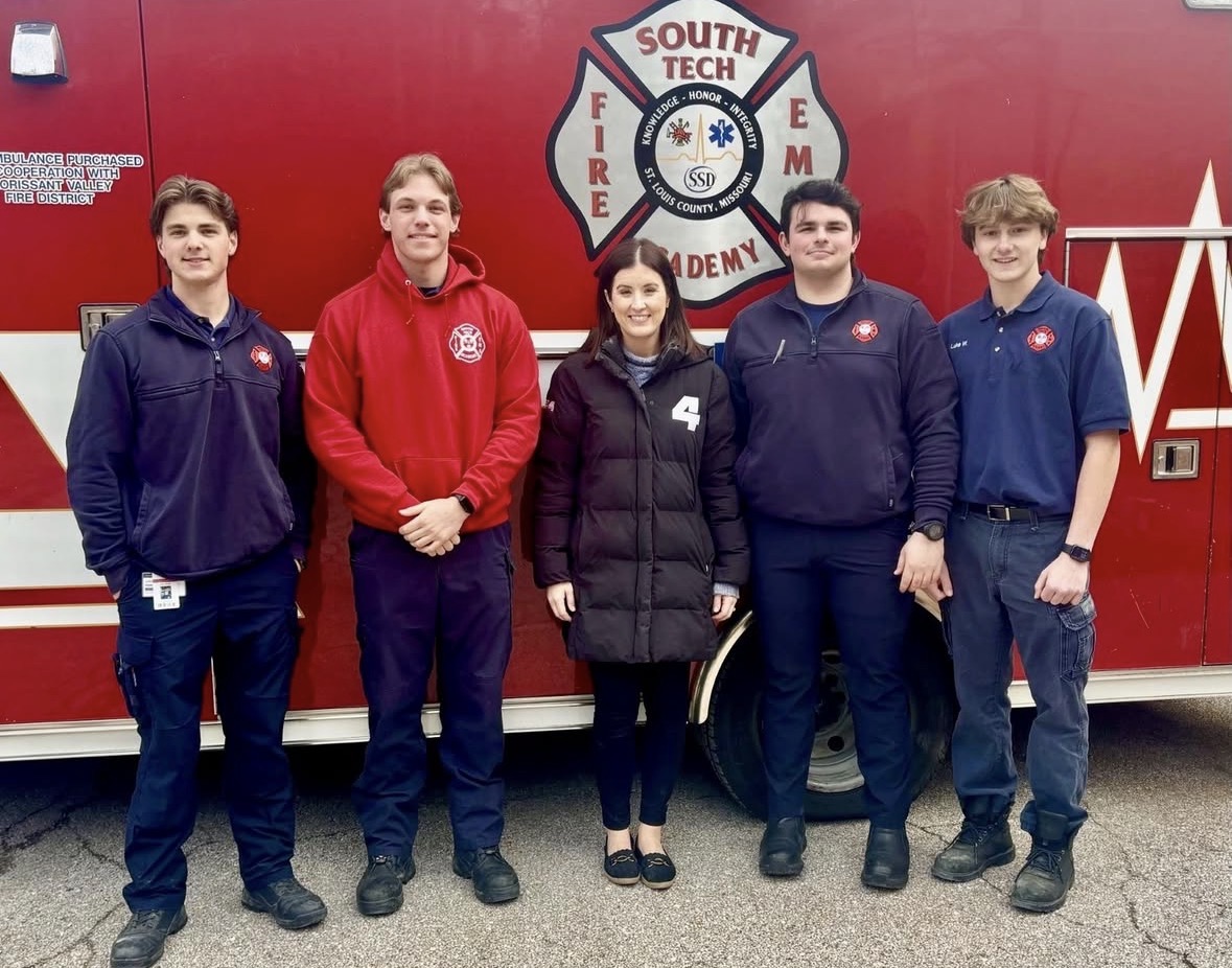 Senior Jack Wright (far left) and senior Luke Wohldmann (far right) take a picture with KMOV journalist Caroline Hecker along with two other students from Eureka High School.