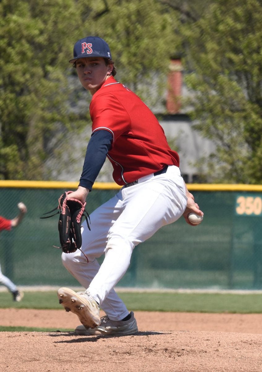 Junior Jacob Hurst warms up on the mound in a game last season. Now a senior, Hurst will be one of the leaders of the Patriots this season.
