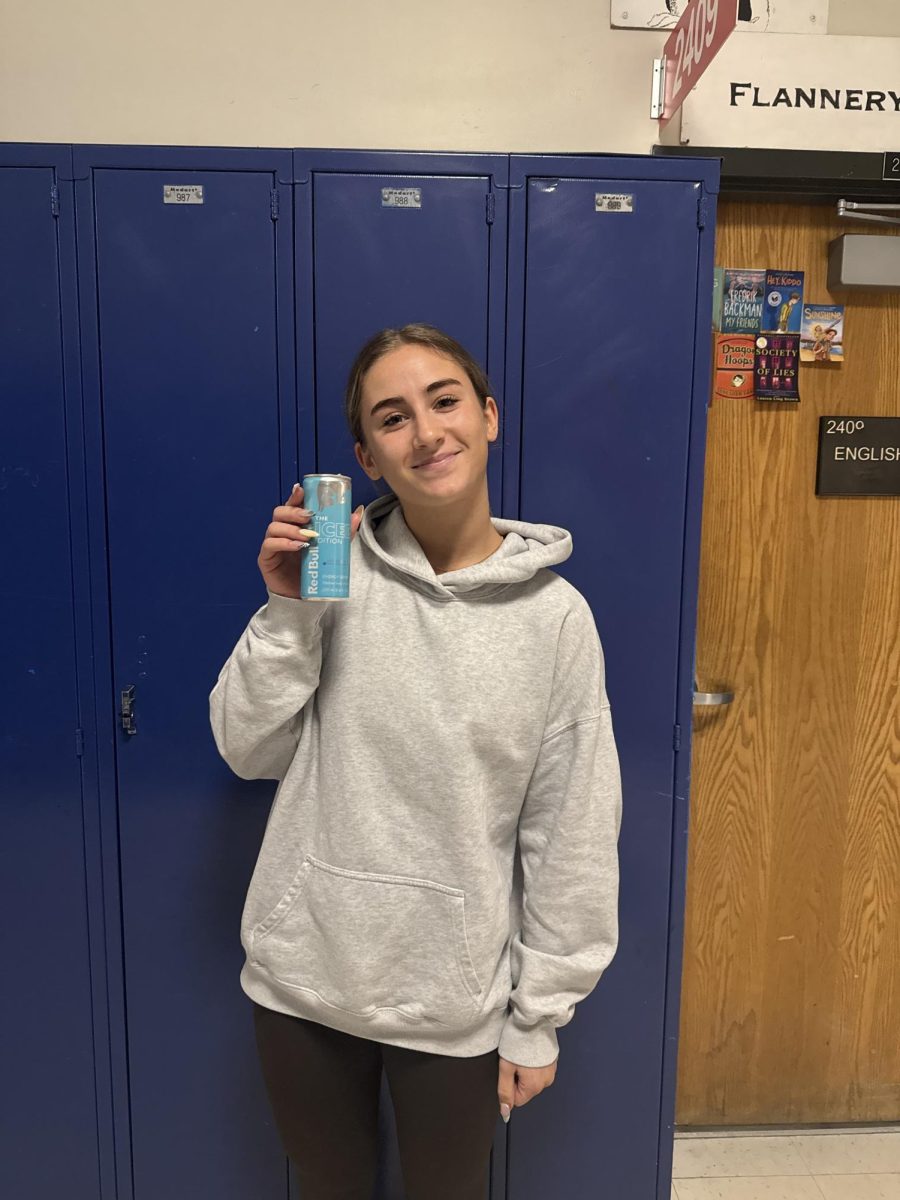 Senior Avery Godwin holds up her can of Ice Edition Red Bull at school on March 11.