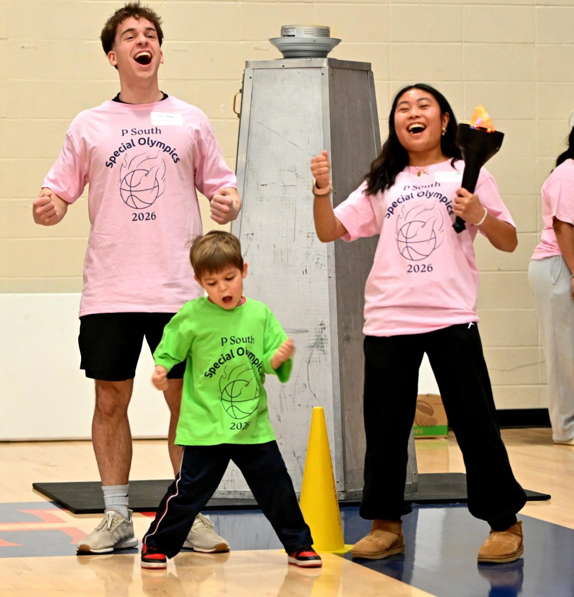 Special Olympics buddies, junior Ethan Gregg and sophomore Chloe Rodriguez, and athlete Emmett celebrate after they announced Emmett’s school, during the Special Olympics torch relay. At the torch relay, the athletes had to pass the torch from one person to the next, eventually until the last athlete placed it on the cauldron to start the tournament. “[My favorite moment was] when Emmett kept going back for Dum-Dums at the swim and dive event in Victory Village. I loved seeing him enjoy all the activities, like playing games or getting prizes," Rodriguez said.