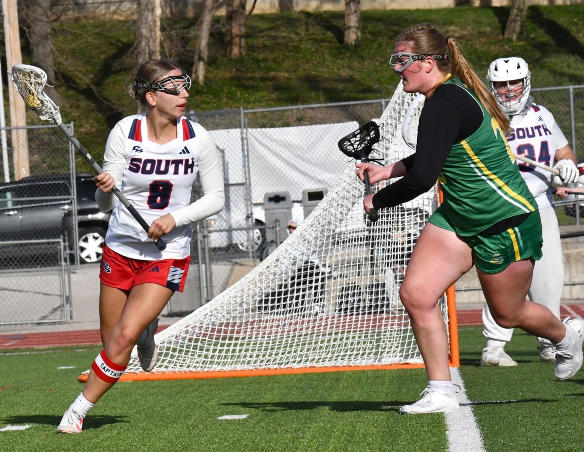 After the Lindbergh attacker drops the ball, senior Abby Karl scoops it up with her stick and looks for a pass up the field. The Patriots won the game 11-9 against the Lindbergh Flyers on March 27. “This season I want 100 goals, but I’m at 70 goals right now. Just a couple more to go. I play for a club and love the environment of the team, and I wanted to continue to play in high school,” Karl said.