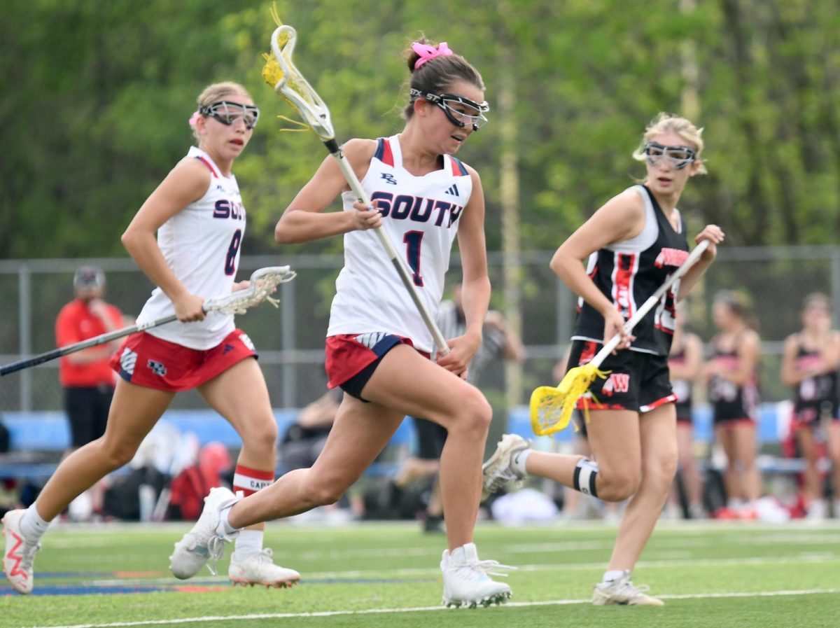 With the ball in her net, sophomore Alexis Wright streaks down the field to try to score against Fox, April 16. 