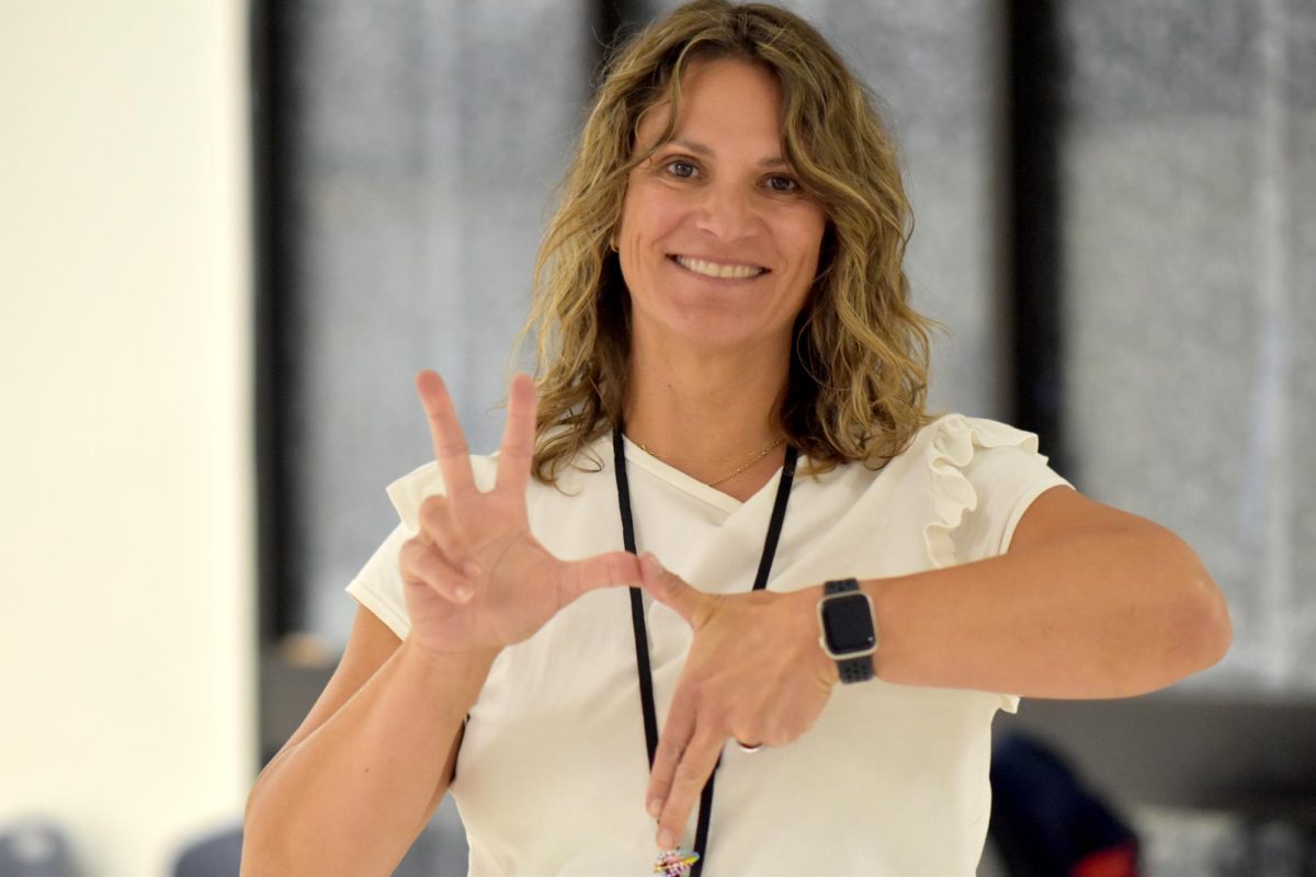 Parkway South aide Kelly Grant shows the sign for her sorority, Kappa Kappa Gamma. 