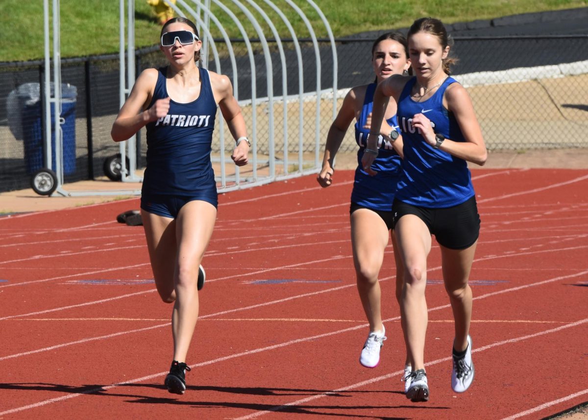 Running the 800-meter event at Northwest, junior Jocelyn Jenks passes two opponents. 
