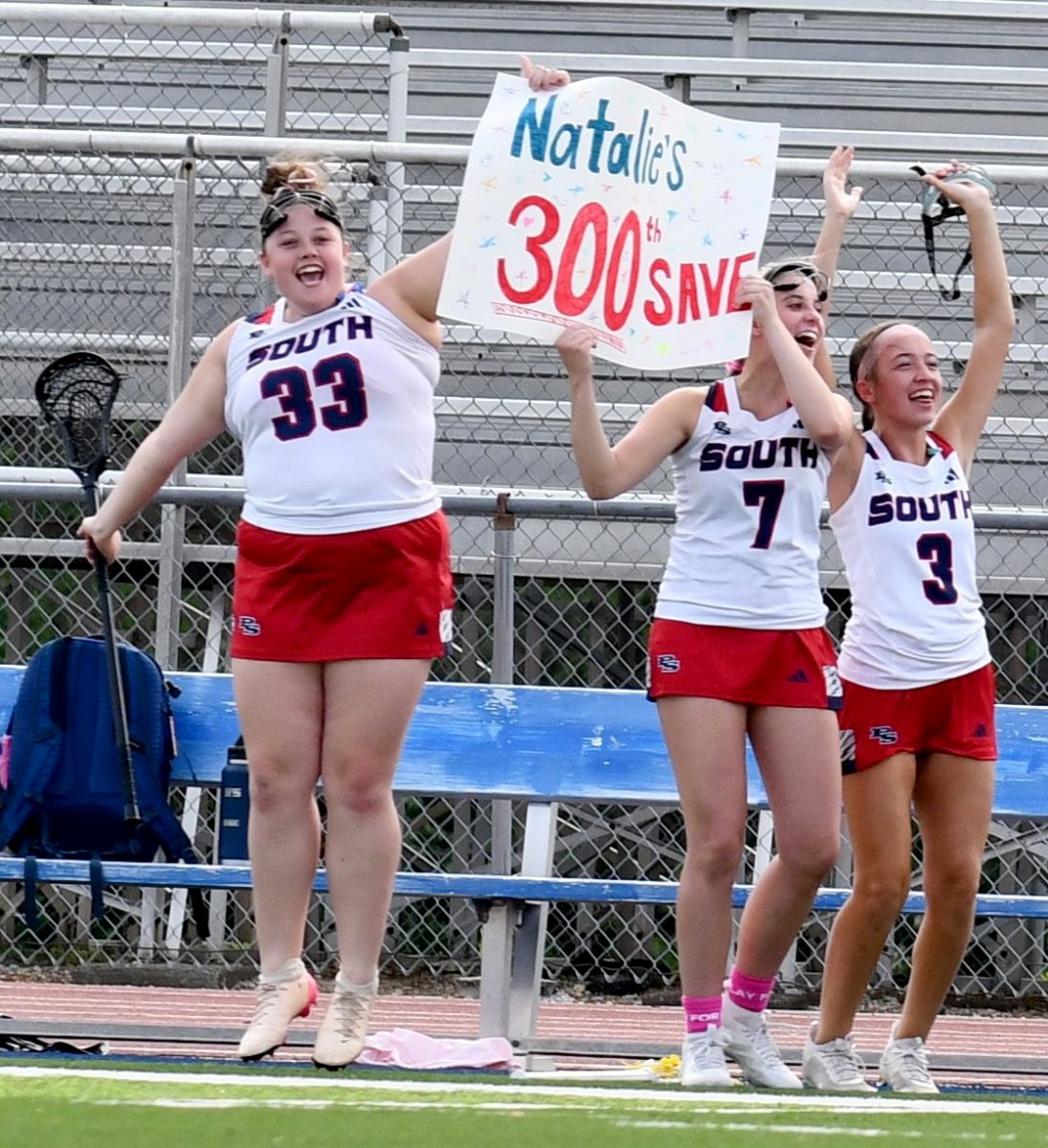 Senior Kaylynn Coleman, junior Bri Clifton, and junior Lilly O’Shea celebrate as their teammate, senior Natalie Parra, earns her 300th save at the game against Fox, April 17. The Patriots beat the Warriors, 14-6, extending their undefeated record to 8-0. “Natalie’s a big part of our program. She’s one of the main reason’s we’re undefeated. We can always count on her. It’s going to be real upsetting when she graduates this year because she has left a big impact on the entire team,” said Clifton.