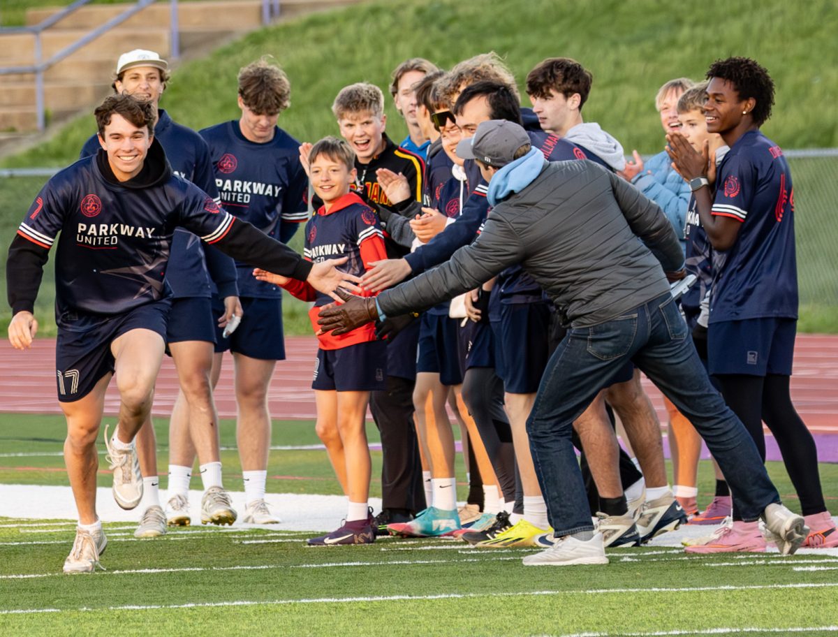 Senior Jacob Hurst runs out onto the field at Parkway North at the start of the Parkway United ultimate frisbee game against SLUH, April 18. Hurst was the only player from South on the team this season. 