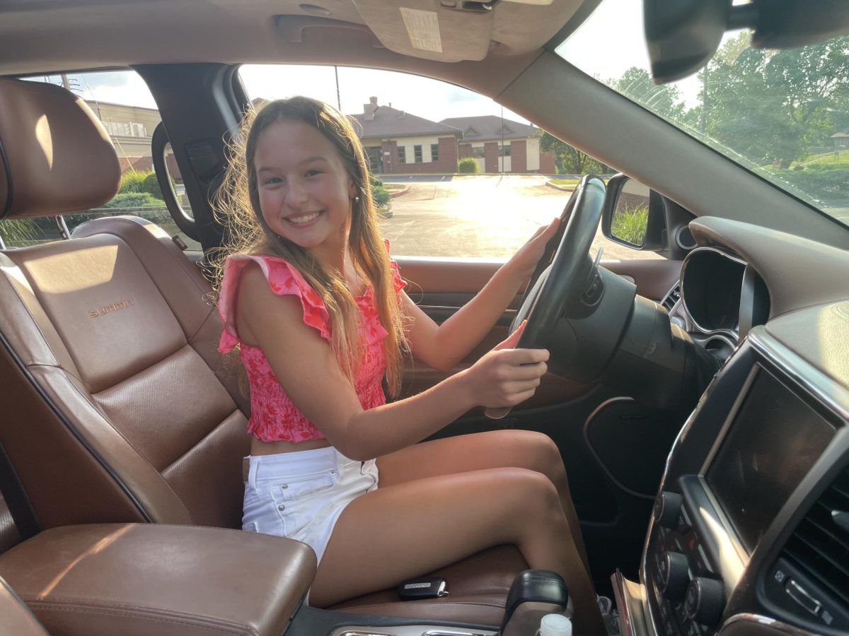 Freshman Carys Woerner takes a picture behind the wheel. Woerner has her permit and is currently learning how to drive.