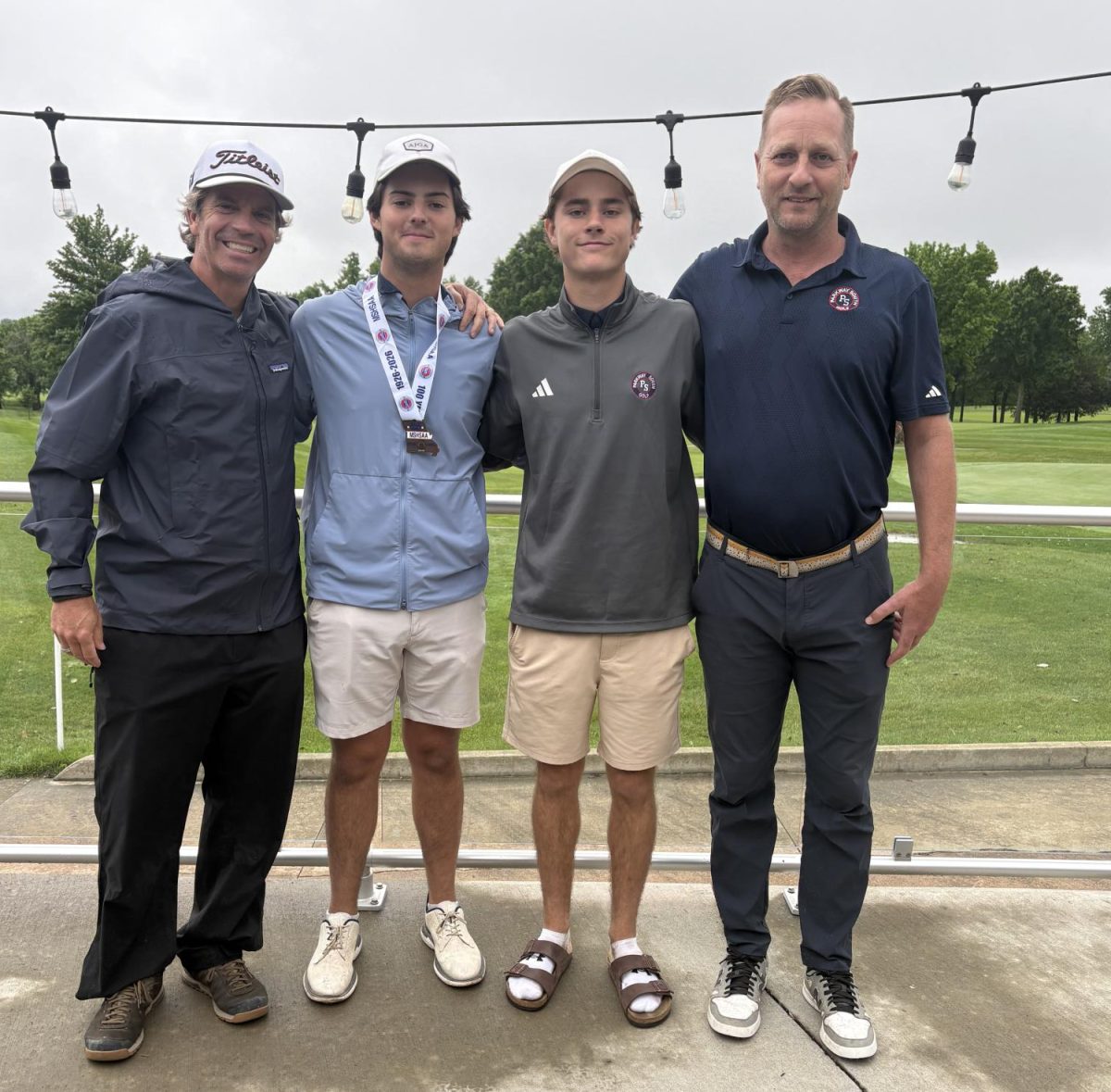 Coach Thomas Williams and Assistant Coach Mitch Stevens take a picture with seniors Matthew Delanty and Tristan Jones after the state tournament.